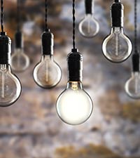 A group of bare lightbulbs hanging with wire. 